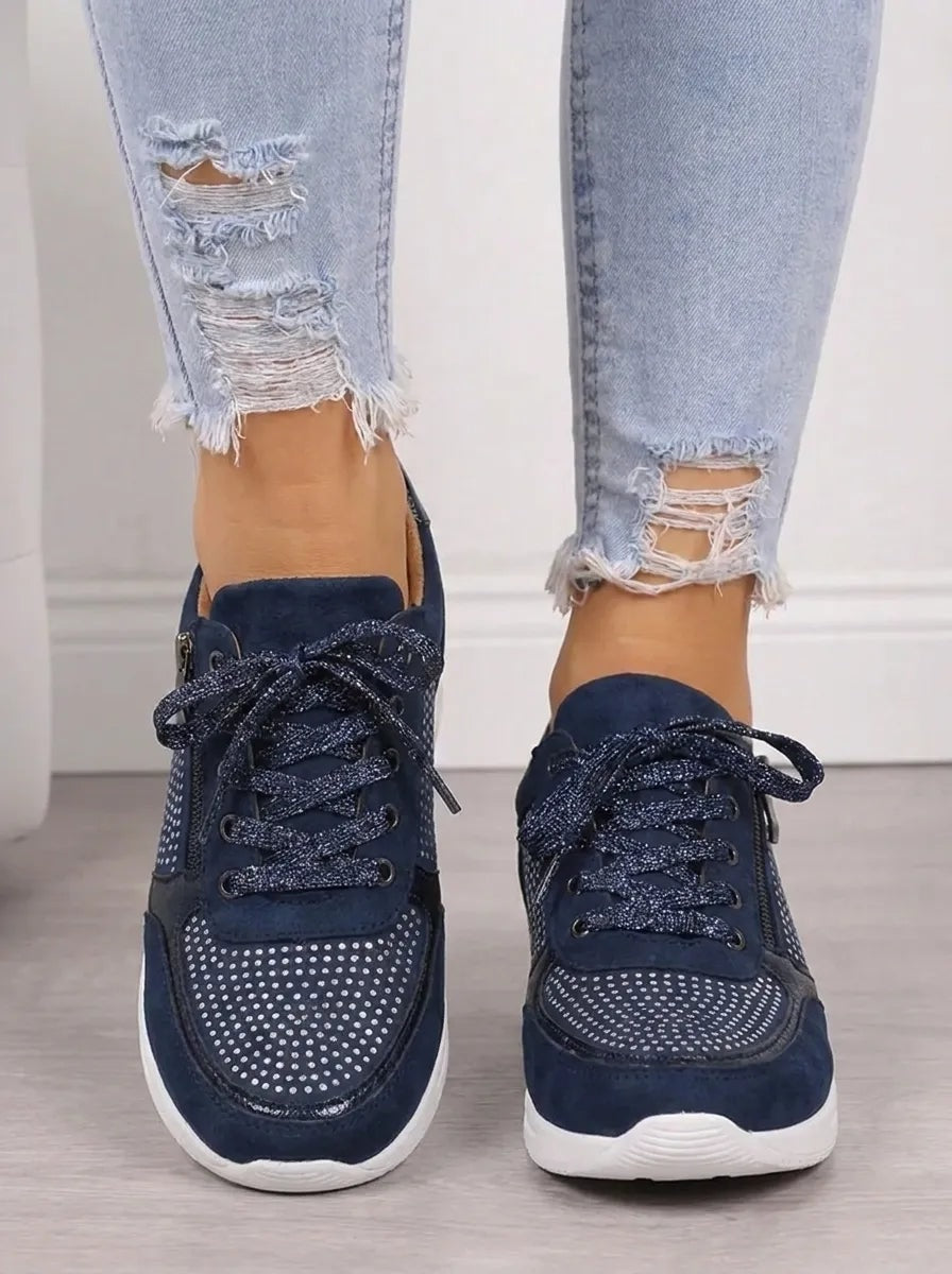 Front view of navy low-top women's sneakers with glittery laces, sparkling toe panels, and contrasting white soles.