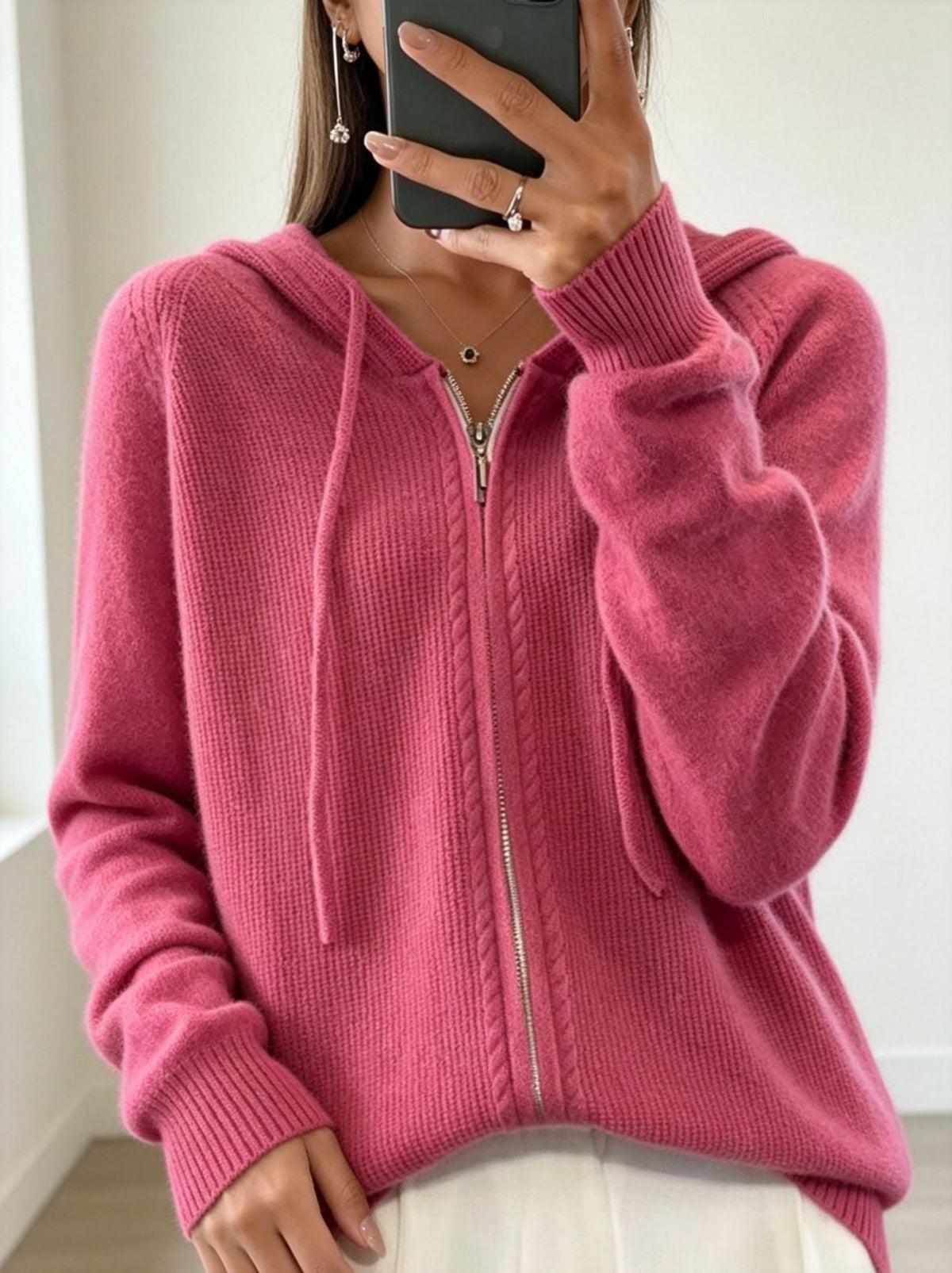 Rose pink zip-up cardigan showing its hood, front zipper, long sleeves and ribbed hem.